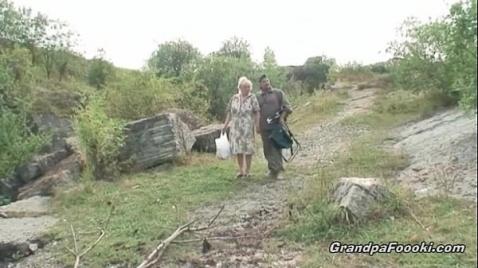 Uma loira despida perto de um casal de idosos.